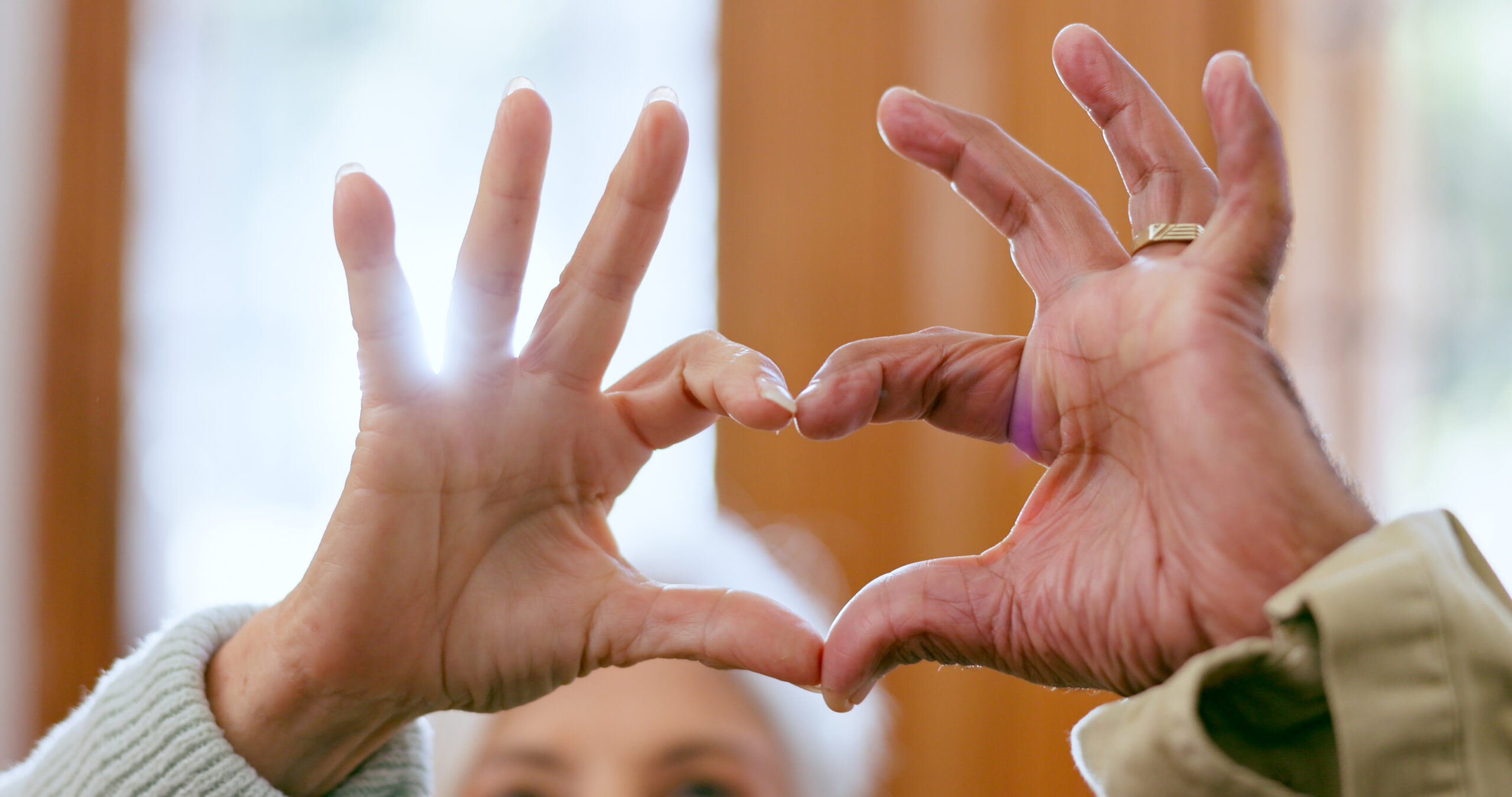 closeup-home-and-senior-couple-with-heart-hands-2023-11-27-04-55-58-utc