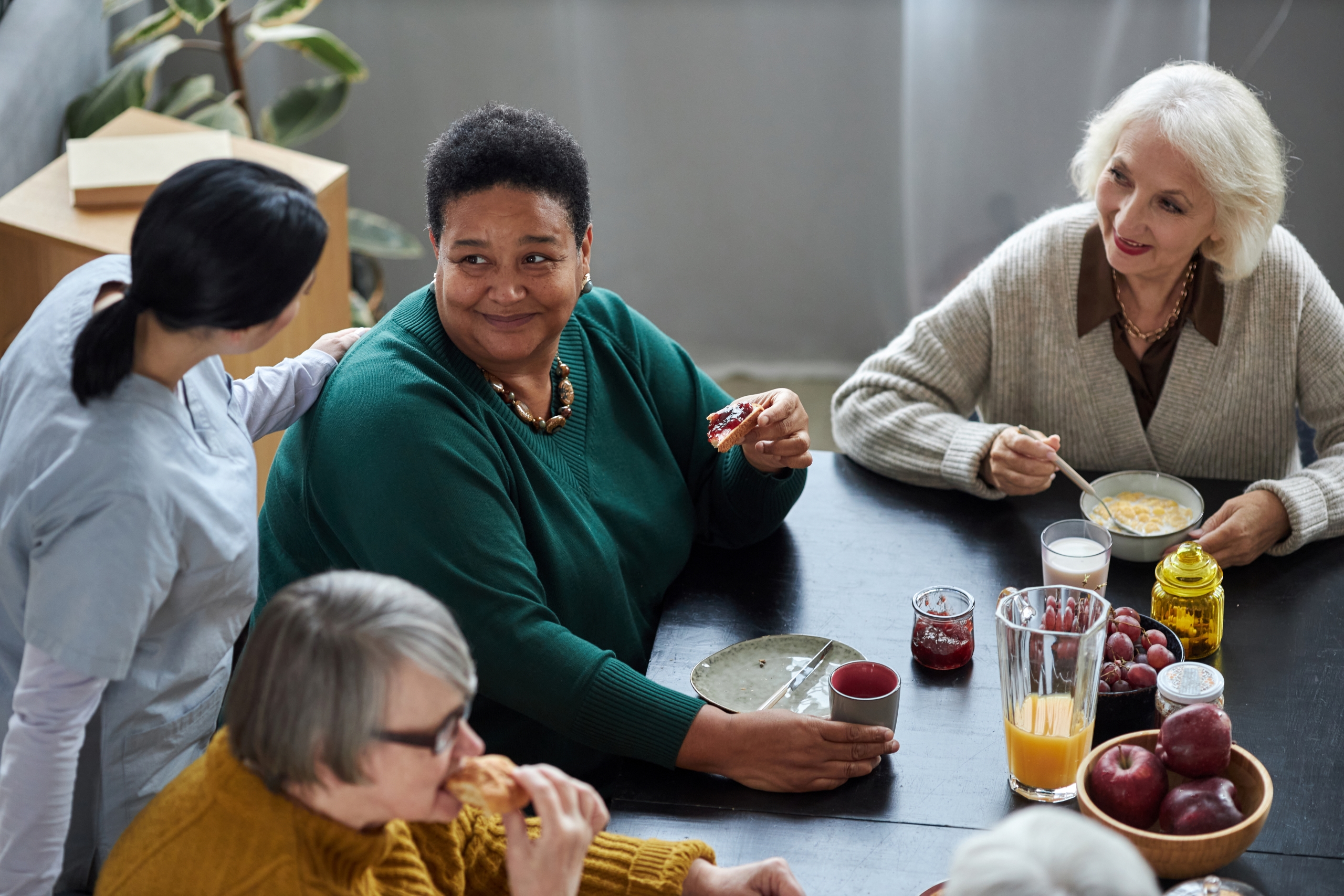 seniors-at-breakfast-in-retirement-home-with-young-2023-11-27-04-55-23-utc1